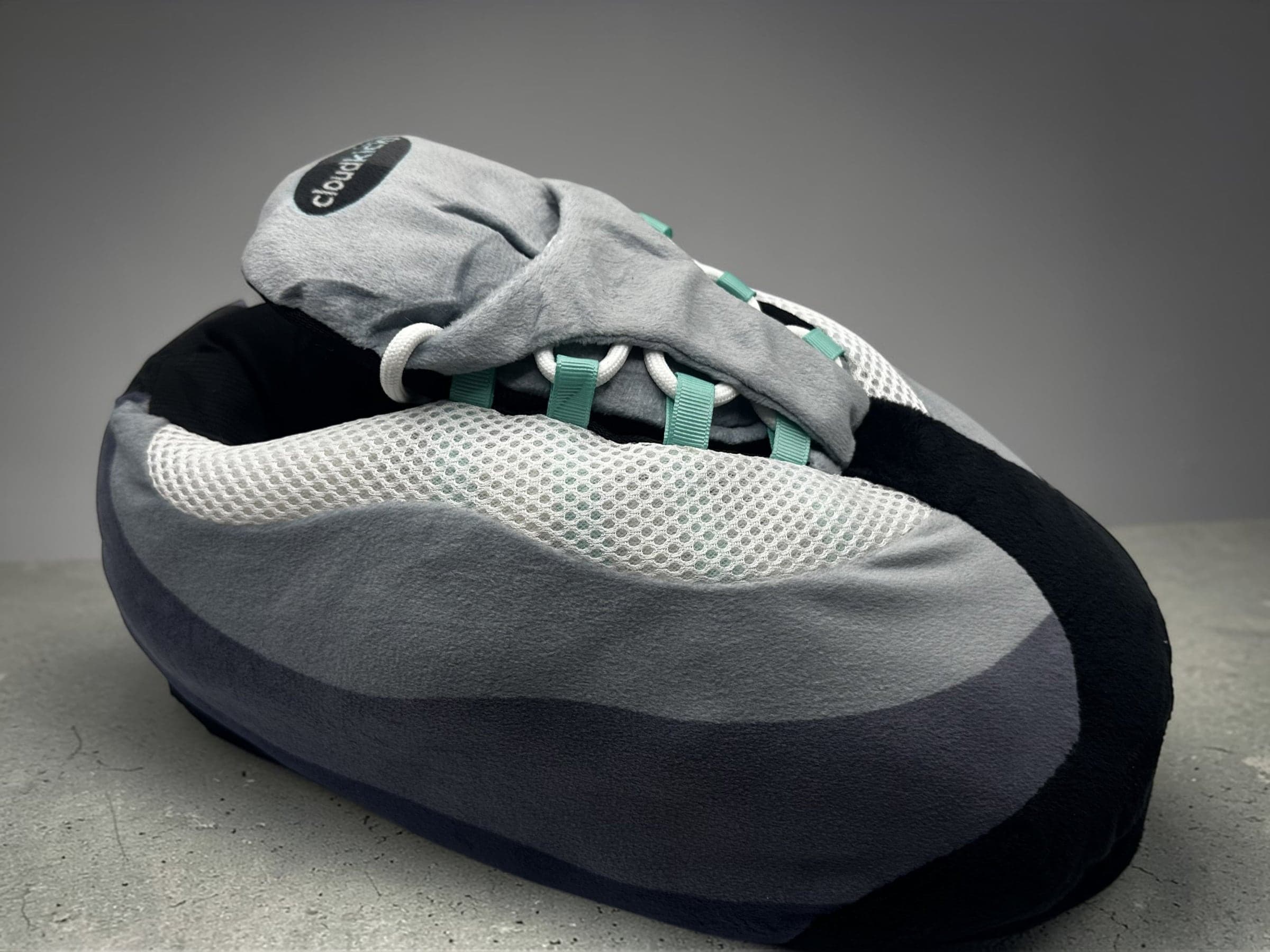 Hyper Turquoise CloudKick showing its oversized silhouette and black heel stripe